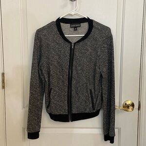 Juniors knit bomber jacket with faux leather trim at zippers.